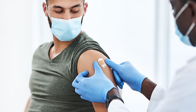 Young man getting a flu shot