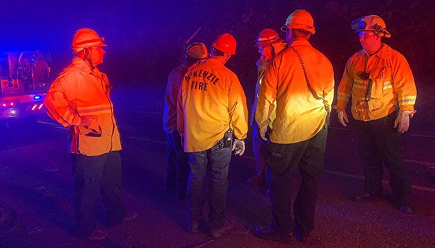 Firefighters consult about the Holiday Farm fire