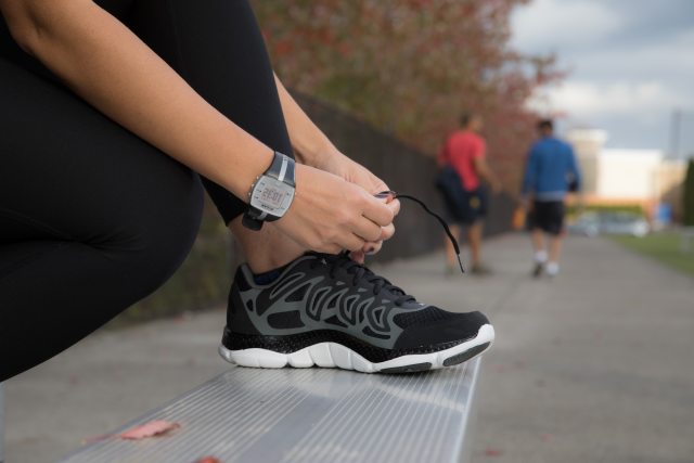 Person ties shoe in anticipation of run or walk.