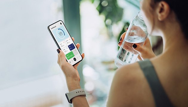 Woman checks her smartphone after exercising