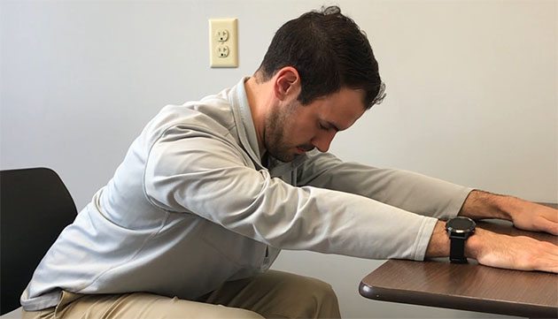 Patrick from physical therapy at PeaceHealth stretches his upper back