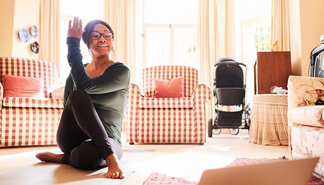 Young mom does yoga on floor
