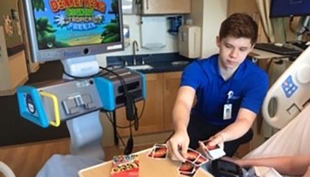 Zach Garrison plays cards with a patient
